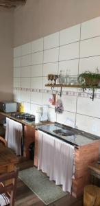a kitchen with a sink and a counter top at Casa Natturvibe - Praia do Rosa in Praia do Rosa