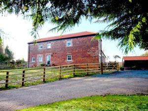 a brick building with a fence in front of it at Beechwood Cottage in Middlesbrough