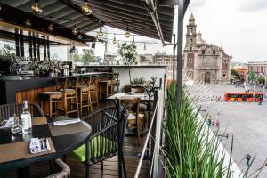 a restaurant with tables and chairs and a street at Domingo Santo Hotel Boutique in Mexico City