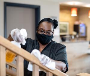 a woman wearing a face mask and gloves at Country Inn & Suites by Radisson, BWI Airport (Baltimore), MD in Linthicum Heights