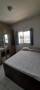 a bedroom with a large bed and a window at Ap05-A 50 Metros da Praia Flats Mobiliados para 6 Pessoas in Paulista +10 photos