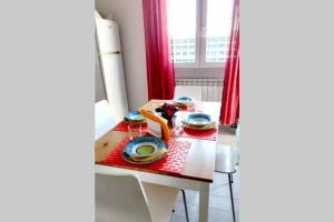 a small table with plates and a red table cloth at La playa nei pressi del mare in Montesilvano