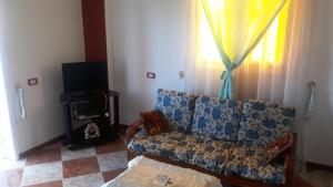 a living room with a couch and a window at Adam and Eve House in Luxor