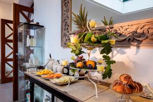 a table with a bunch of fruits and vegetables on it at Tenuta Del Poggio Antico in Ischia