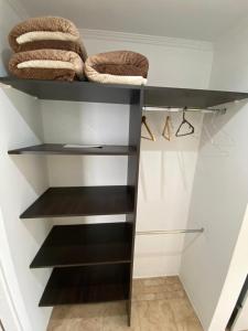 a walk in closet with black and white shelves at Apartamento Lo de Ana in Termas de Río Hondo