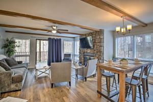 a living room with a table and a fireplace at Mount Ida Condo - Walk to Lake Ouachita! in Mount Ida