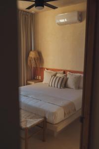 Postel nebo postele na pokoji v ubytování Casa Peregrino Holbox