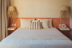 Postel nebo postele na pokoji v ubytování Casa Peregrino Holbox