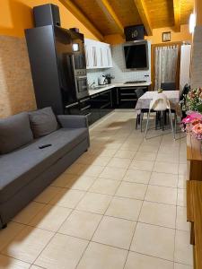 a living room with a couch and a kitchen at Cozy home in Pertegada
