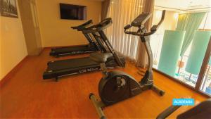 a gym with three exercise bikes in a room at Vila Galé Paulista in Sao Paulo