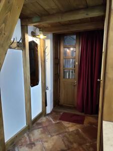 a room with a door and a red curtain at Apartments XVII Century in Lviv