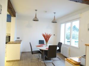 a kitchen and dining room with a table and chairs at Le Panorama - Vue mer in Criel-sur-Mer