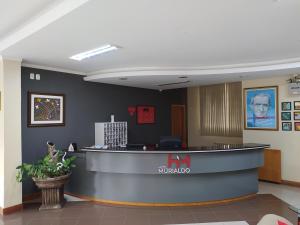 a waiting room with a counter in a hospital at Hotel Murialdo in Caxias do Sul