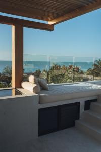 a balcony with a view of the ocean at Casa Peregrino Holbox in Holbox Island