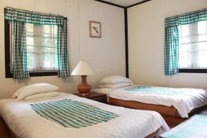Postel nebo postele na pokoji v ubytování Mae Sa Valley Garden Resort