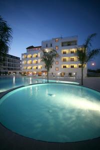 a large swimming pool in front of a building at Forte Hotel in Vieste