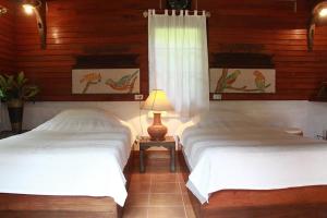 Postel nebo postele na pokoji v ubytování Mae Sa Valley Garden Resort