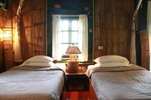 Postel nebo postele na pokoji v ubytování Mae Sa Valley Garden Resort
