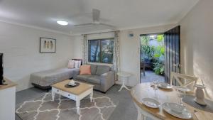 a living room with a couch and a table at Grafton Lodge Motel in Grafton