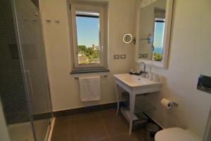 a bathroom with a sink and a shower and a mirror at Tenuta Del Poggio Antico in Ischia