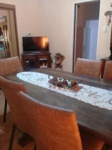 a dining room table with chairs and a table with a centerpiece at Casa Quinta en Luján - Olivera in Olivera