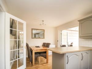a kitchen with a table and chairs and a dining room at Cornerways in Kirkby Thore