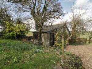 a small cottage in the middle of a field at The Mouse House in Blandford Forum