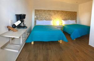 Postel nebo postele na pokoji v ubytování HOTEL COLIBRÍ