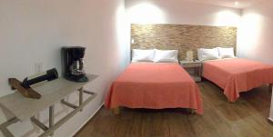 Postel nebo postele na pokoji v ubytování HOTEL COLIBRÍ
