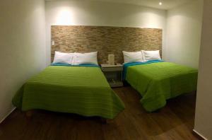 Postel nebo postele na pokoji v ubytování HOTEL COLIBRÍ