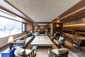 a lobby with a couch and chairs and a table at Solaria Nishitetsu Hotel Sapporo in Sapporo