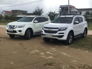 two white trucks parked next to each other at Homestay Minh Nguyên in Hue