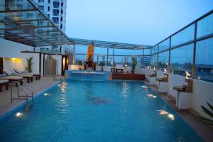 a large swimming pool on the roof of a building at Gokulam Park in Cochin
