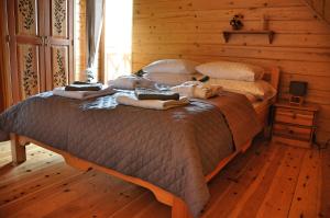 a dog laying on a bed in a bedroom at Cichy Zakątek in Ujsoły