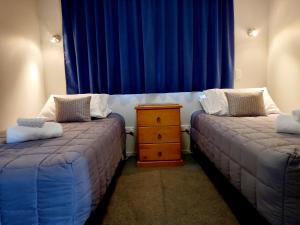 Postel nebo postele na pokoji v ubytování Academy Lodge Motel