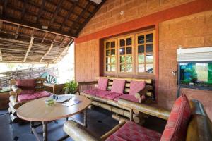 a living room with a couch and a table at Hanchina Mane Homestay in Gokarna