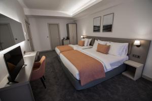 A bed or beds in a room at Dovv Hotel Busıness
