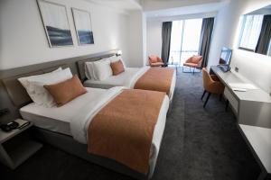 A bed or beds in a room at Dovv Hotel Busıness