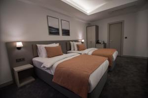 A bed or beds in a room at Dovv Hotel Busıness