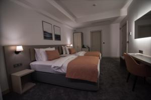 A bed or beds in a room at Dovv Hotel Busıness