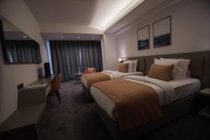 A bed or beds in a room at Dovv Hotel Busıness