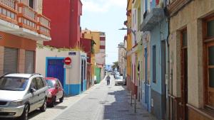 a street with cars parked on the side of a building at Fleitas Penthouse with terrace in San Andrés