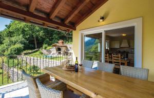 a wooden table and chairs on a patio at Villa Sirotnjak in Lovran