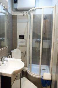 a bathroom with a shower and a toilet and a sink at EURO-ROOM in Krakow