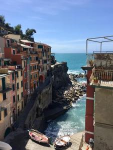 a group of buildings and boats in the water at Sara Apartment, Comfort and lateral sea view in Riomaggiore