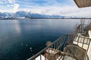 a view from a boat of a lake and mountains at Hotel Restaurant Bellevue au Lac in Thun
