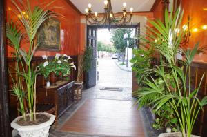 an entrance to a building with plants and a door at Hotel Palacio Carlos I in Villaviciosa