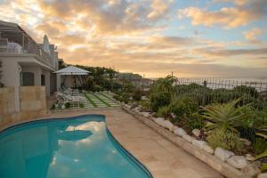 a swimming pool in the backyard of a house at Last Word Long Beach in Kommetjie