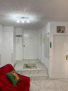 a living room with a red couch in a room at Cannes Apartment close to Congress Palace, Croisette, Beaches in Cannes
