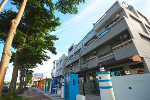 a building with a blue and white pole in front of it at Fun Trip - Little Castle & Oscar B&B in Taitung City